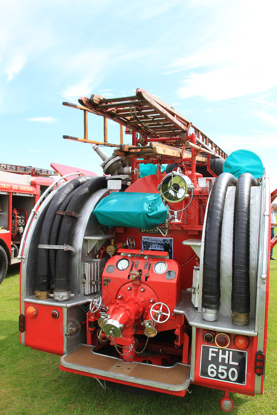 IMG 9431 
 Rear view of 'Dennis' fire engine, showing fire fighting equipment detail. 
 Keywords: Dennis Fire Engine Rear View Ladder Hose Equipment Red Emergency Vehicle Water Tender Rescue